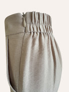 Close-up of beige pants with an elastic waistband on a light background